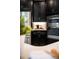 Close up of a kitchen with stainless appliances, dark cabinetry, and stylish countertop decor at 1219 Verdant Glade Pl, Winter Park, FL 32792