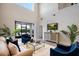 Bright living room has a high ceiling and a sliding glass door leading to the patio at 1219 Verdant Glade Pl, Winter Park, FL 32792