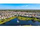 An aerial view of a large neighborhood near a big lake on a bright sunny day at 1312 Blue Stem Ln, Winter Park, FL 32792