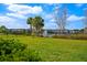 Lush green backyard with a black fence surrounding the property and beautiful lake views at 1312 Blue Stem Ln, Winter Park, FL 32792