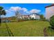Spacious backyard with lush green grass, black metal fence, and a scenic lake view at 1312 Blue Stem Ln, Winter Park, FL 32792