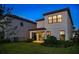 Rear exterior view of home featuring a lawn, and a covered patio with sliding glass doors at 1312 Blue Stem Ln, Winter Park, FL 32792