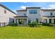 A spacious backyard featuring lush grass, well-kept landscaping, and a charming patio at 1312 Blue Stem Ln, Winter Park, FL 32792
