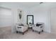 Cozy bedroom features two chairs, a decorative mirror, neutral paint, and soft, neutral carpet at 1312 Blue Stem Ln, Winter Park, FL 32792