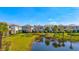 Scenic community homes line the lake, featuring lush landscaping, palm trees, and backyard ponds at 1312 Blue Stem Ln, Winter Park, FL 32792