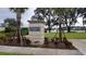 A welcoming entrance sign for Terminus Park, set amidst beautiful landscaping and a view of the community lake at 1312 Blue Stem Ln, Winter Park, FL 32792