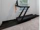 A black treadmill sits on a black mat by a window in the exercise room at 1312 Blue Stem Ln, Winter Park, FL 32792