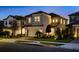 Inviting two-story home featuring a gray exterior, two car garage, and landscaped front yard at 1312 Blue Stem Ln, Winter Park, FL 32792