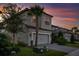 Two-story home showcasing a gray exterior, landscaped yard, and a two-car garage at 1312 Blue Stem Ln, Winter Park, FL 32792