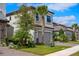 A two-story home featuring well-maintained landscaping, a two-car garage, and a brick driveway at 1312 Blue Stem Ln, Winter Park, FL 32792