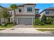 Charming two-story home with a two-car garage, paved driveway and landscaped front yard at 1312 Blue Stem Ln, Winter Park, FL 32792