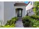 Elegant front entrance featuring a decorative glass door, a brick pathway, and lush landscaping, creating a welcoming approach at 1312 Blue Stem Ln, Winter Park, FL 32792