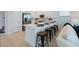 Modern kitchen island with bar stools and a view to the living area for easy entertaining at 1312 Blue Stem Ln, Winter Park, FL 32792