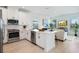 Bright kitchen with stainless-steel appliances, island seating, and an open floor plan to the living area at 1312 Blue Stem Ln, Winter Park, FL 32792
