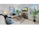 Bright living room features modern decor, comfortable seating, and a stylish entertainment center at 1312 Blue Stem Ln, Winter Park, FL 32792