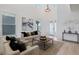 Bright living room featuring high ceilings, neutral-toned furniture, a modern art piece, and plenty of natural light at 1312 Blue Stem Ln, Winter Park, FL 32792