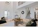 Open-concept living room with high ceilings, staircase, modern decor, and lots of natural light at 1312 Blue Stem Ln, Winter Park, FL 32792