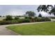 A peaceful park setting with benches, lush greenery, and a sidewalk, creating a serene outdoor space for residents at 1312 Blue Stem Ln, Winter Park, FL 32792