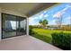 Screened-in patio with a view of the lawn, pond, and palm trees at 1312 Blue Stem Ln, Winter Park, FL 32792