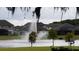 Scenic view of homes across a tranquil pond with a water fountain, highlighting the community's peaceful atmosphere at 1312 Blue Stem Ln, Winter Park, FL 32792