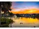 Picturesque pond featuring a fountain and ducks, with residential buildings in the background, all reflected in the water at 1312 Blue Stem Ln, Winter Park, FL 32792