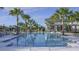 A refreshing pool is centered between palm trees and lounge chairs at 1312 Blue Stem Ln, Winter Park, FL 32792