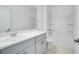 Bright bathroom includes a tub, shower, toilet, and modern vanity with grey cabinets at 142 Jones Fish Camp Rd, Edgewater, FL 32141