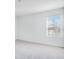Bright, empty bedroom with carpeted floors and a large window at 142 Jones Fish Camp Rd, Edgewater, FL 32141