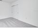 Bright bedroom features a closet and neutral carpeting for versatile styling options at 142 Jones Fish Camp Rd, Edgewater, FL 32141
