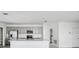 Modern kitchen featuring stainless steel appliances, gray cabinets, quartz countertops, and a spacious island at 142 Jones Fish Camp Rd, Edgewater, FL 32141