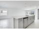 Open-concept kitchen featuring an island with sink and gray cabinetry at 142 Jones Fish Camp Rd, Edgewater, FL 32141