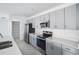 Stylish kitchen featuring stainless steel appliances, gray cabinets, and light countertops at 142 Jones Fish Camp Rd, Edgewater, FL 32141