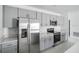 Beautiful kitchen featuring stainless steel appliances, sleek gray cabinets, and stylish countertop at 142 Jones Fish Camp Rd, Edgewater, FL 32141