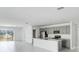 Open-concept living space with the kitchen, dining area, and patio doors at 142 Jones Fish Camp Rd, Edgewater, FL 32141