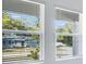 Bright interior shot showcasing view of the yard and surroundings through windows with blinds at 142 Jones Fish Camp Rd, Edgewater, FL 32141