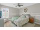 Bright bedroom featuring a queen bed, wood flooring, and large window at 1616 Thornhill Cir, Oviedo, FL 32765