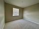 A standard-sized bedroom with carpet flooring, a neutral color palette, and a window at 2742 Carrickton Cir, Orlando, FL 32824