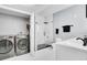 Main bathroom with washer and dryer, shower, and vanity at 304 E South St # 5029, Orlando, FL 32801