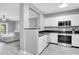 Modern kitchen with white cabinets, stainless steel appliances, and dark countertops at 304 E South St # 5029, Orlando, FL 32801