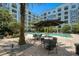 Resort-style pool with patio tables and umbrellas at 304 E South St # 5029, Orlando, FL 32801