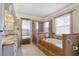 Spa-like bathroom with granite counters, a walk-in shower, and a separate soaking tub at 3871 Dallas Blvd, Orlando, FL 32833