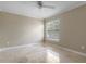 Neutral bedroom with window providing natural light, neutral walls, and tile flooring offering simple elegance at 3871 Dallas Blvd, Orlando, FL 32833