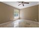 Bright bedroom with window providing natural light, neutral walls, and tile flooring offering simple elegance at 3871 Dallas Blvd, Orlando, FL 32833