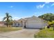 Charming single-story home with a two-car garage, a well-manicured lawn and mature landscaping at 3871 Dallas Blvd, Orlando, FL 32833
