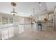 Bright and airy living room featuring elegant marble floors, a kitchen bar, and seamless access to outdoor spaces at 3871 Dallas Blvd, Orlando, FL 32833
