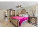 Luxurious bedroom with ornate furnishings, a ceiling fan, and soft lighting exudes comfort and sophistication at 3871 Dallas Blvd, Orlando, FL 32833