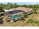 Aerial view of a screened-in pool and deck with mature tropical landscaping at 3871 Dallas Blvd, Orlando, FL 32833