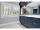 Modern bathroom with white cabinets and marble countertops at 450 Cherokee Dr, Orlando, FL 32801