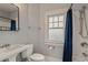 Clean bathroom with pedestal sink, shower, and window at 450 Cherokee Dr, Orlando, FL 32801