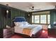 Main bedroom with a king-size bed, dark wood furniture and a ceiling fan at 450 Cherokee Dr, Orlando, FL 32801